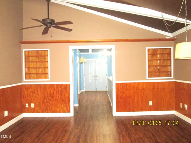 a view of a room with a window and wooden floor