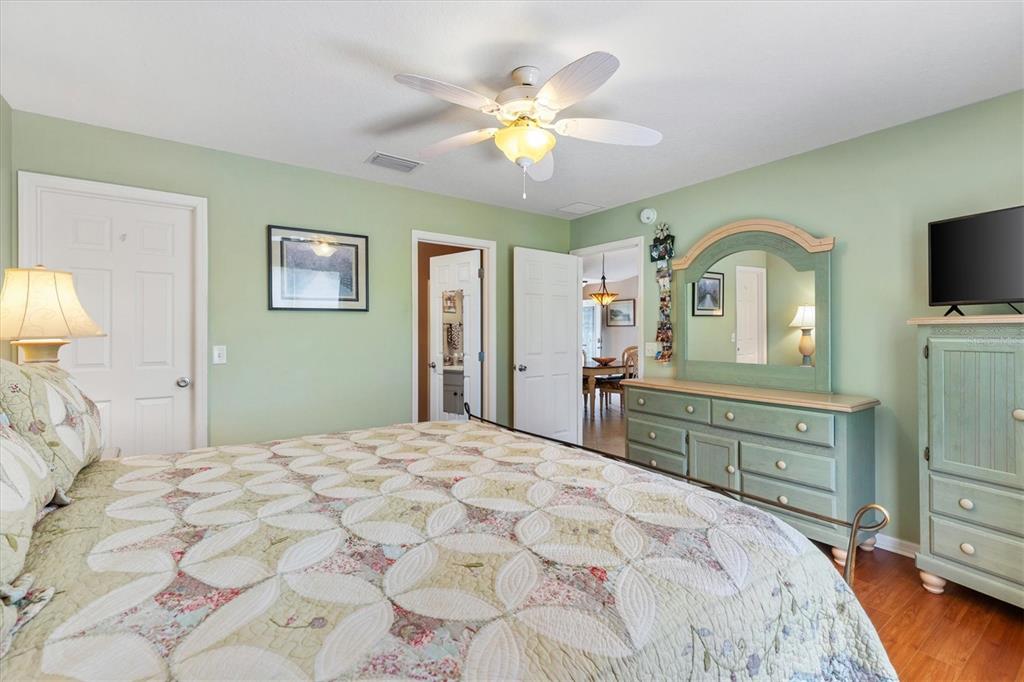 470 Oboe Way The Villages, FL 32162 - Photo 14 of 42 a bedroom with a bed and a chandelier