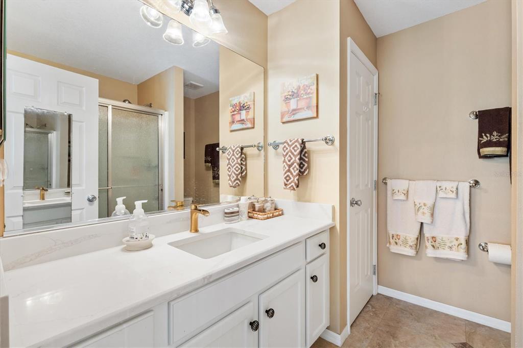 470 Oboe Way The Villages, FL 32162 - Photo 15 of 42 a bathroom with double vanity sinks a vanity two mirror and shower
