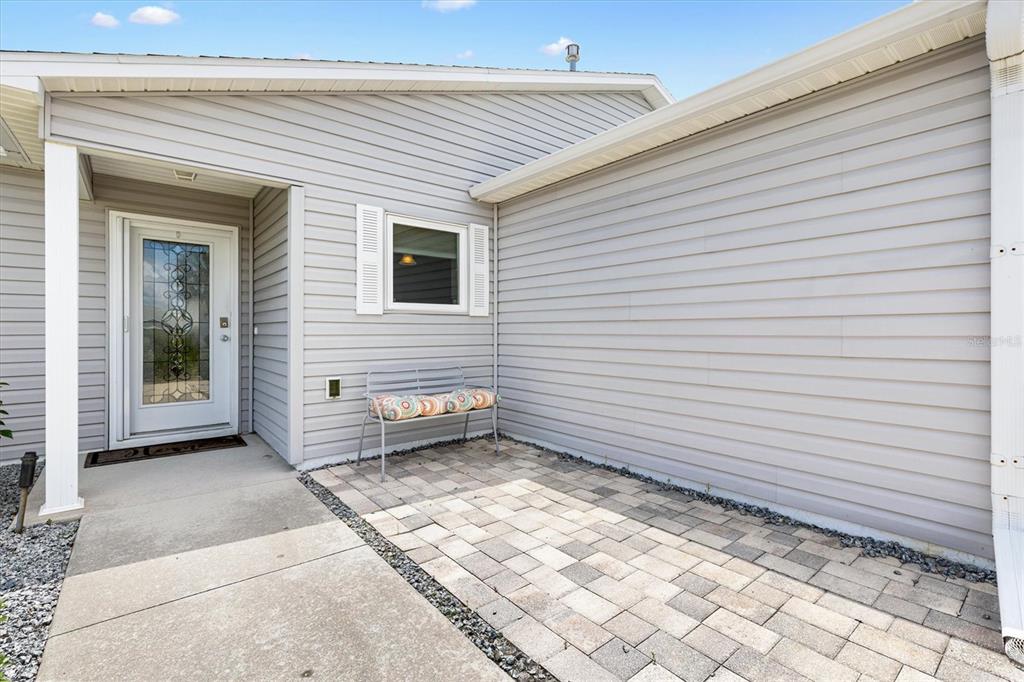 470 Oboe Way The Villages, FL 32162 - Photo 2 of 42 a view of a backyard with a chair and table in front of house