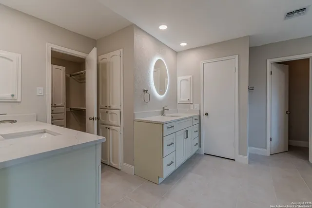 a bathroom with a double vanity sink and a mirror