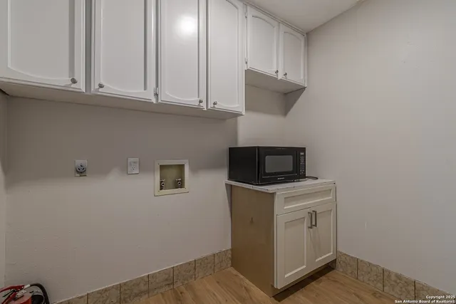 a living room with hard wood floors and a fireplace