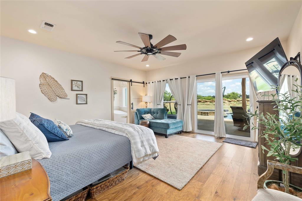 1010 Fm 583 Street West Rising Star, TX 76471 - Photo 24 of 40 a bedroom with a balcony a bed and a chandelier