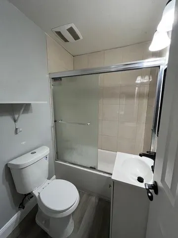 a bathroom with a toilet and a shower