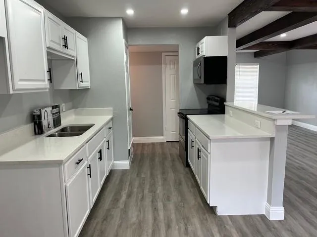 a kitchen with stainless steel appliances a sink and a stove