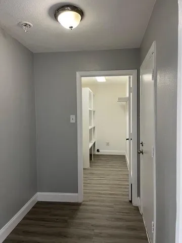 a view of a room with wooden floor