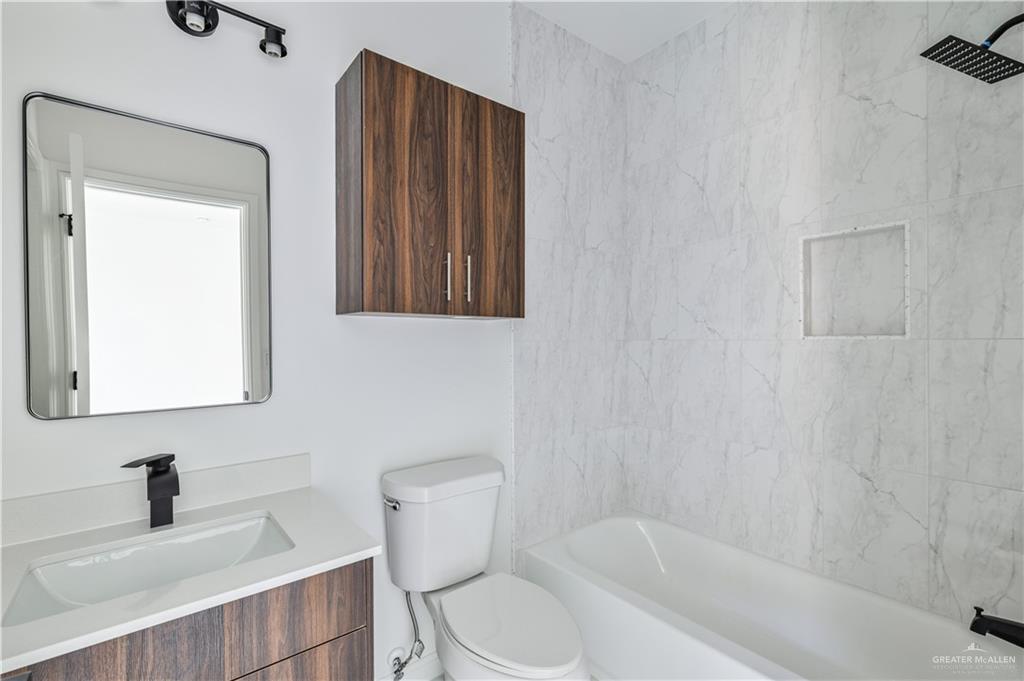 5322 Vision Street Rio Grande City, TX 78582 - Photo 17 of 20 a bathroom with a toilet a sink and bathtub