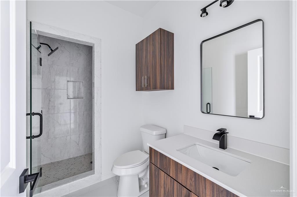 5322 Vision Street Rio Grande City, TX 78582 - Photo 9 of 20 a bathroom with a sink a toilet and shower