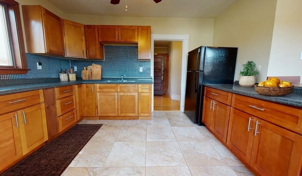 75 Cherry Street, Unit 2 Malden, MA 02148 - Photo 13 of 17 a kitchen with stainless steel appliances granite countertop a refrigerator and a sink