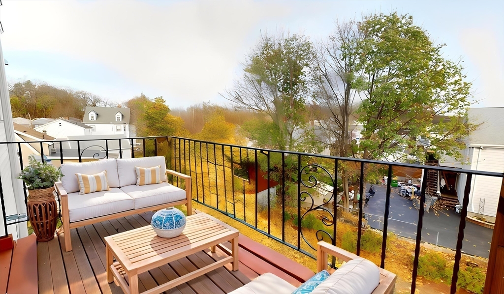 75 Cherry Street, Unit 2 Malden, MA 02148 - Photo 15 of 17 a balcony with wooden floor