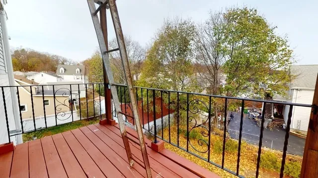 a view of balcony with wooden floor and fence