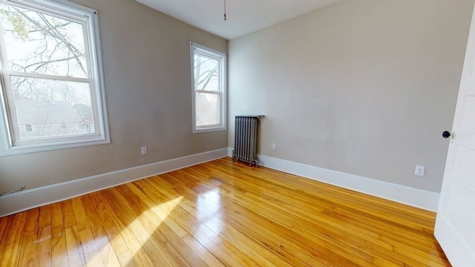 75 Cherry Street, Unit 2 Malden, MA 02148 - Photo 4 of 17 a view of empty room with wooden floor and fan