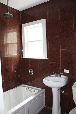 a bathroom with a sink bathtub and a mirror