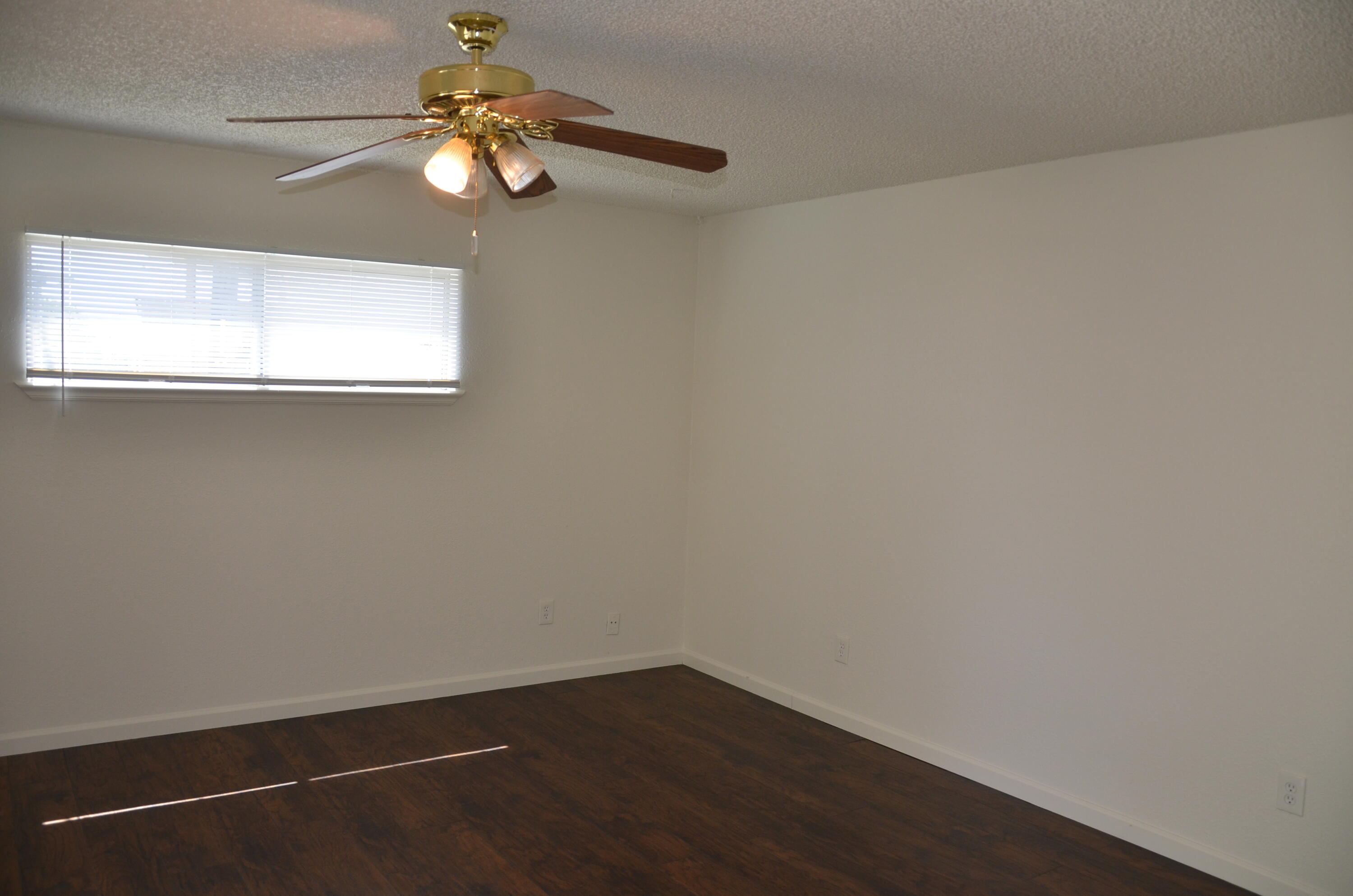 339 West Spring Lane Lemoore, CA 93245 - Photo 24 of 31 a view of a small space with wooden floor and a fan