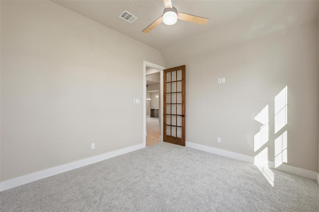 1053 Llano Way Poolville, TX 76487 - Photo 6 of 40 an empty room with windows and fan
