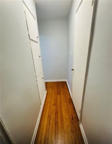 a view of wooden floor in a hallway