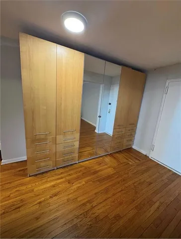 an empty room with wooden floor