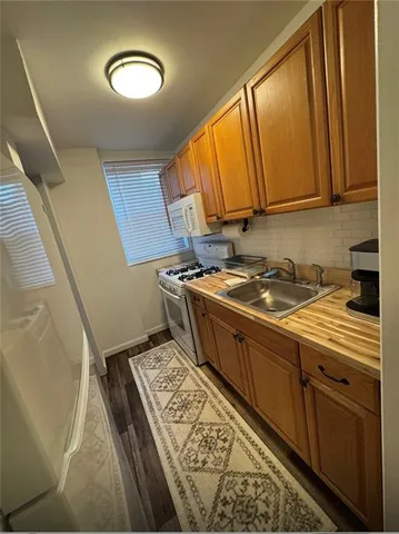 a kitchen with stainless steel appliances wooden cabinets a stove and a refrigerator