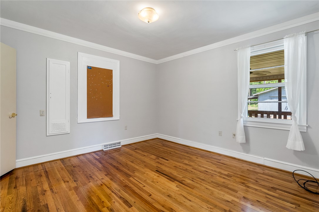 1509 869 Anderson, SC 29621 - Photo 29 of 45 Warm hardwood floors and abundant light define this cozy bedroom space.