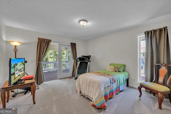 a bedroom with a bed and a two chair