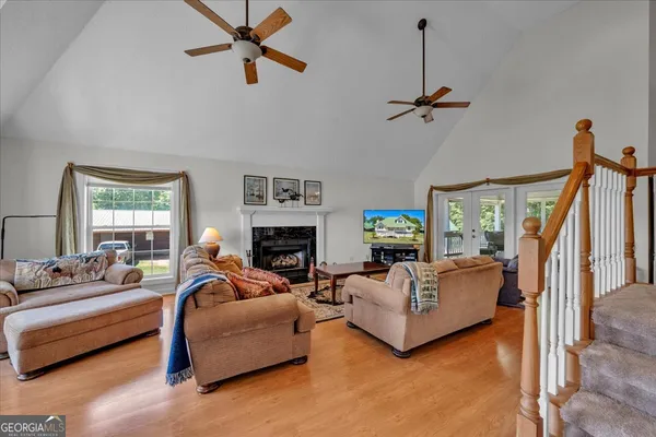 a living room with furniture a fireplace and a window