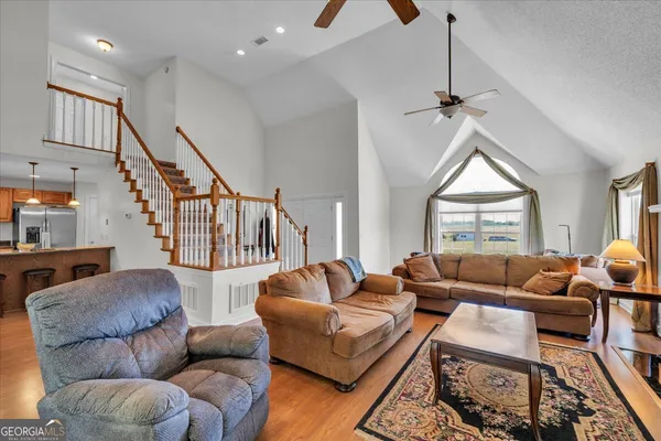 a living room with furniture and wooden floor