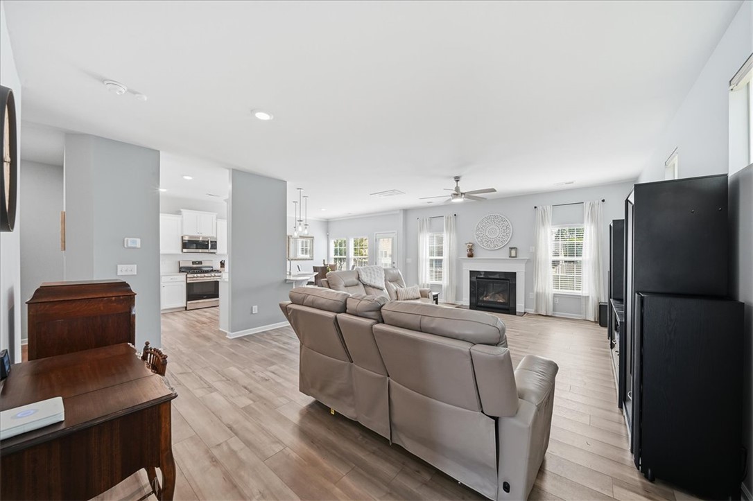 208 Grassy Creek Way Pendleton, SC 29670 - Photo 43 of 43 An open concept floorplan seamlessly connects a well-lit living area with a modern kitchen.