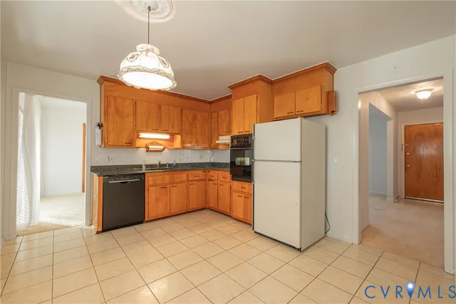 a kitchen with stainless steel appliances granite countertop a refrigerator sink and cabinets