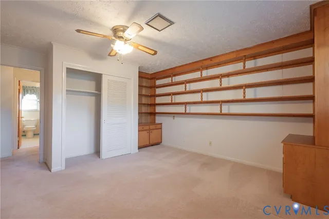 a view of an empty room with a ceiling fan