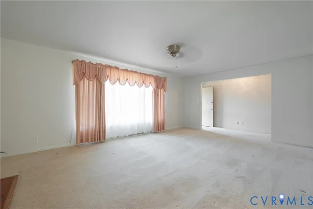 an empty room with windows and entrance