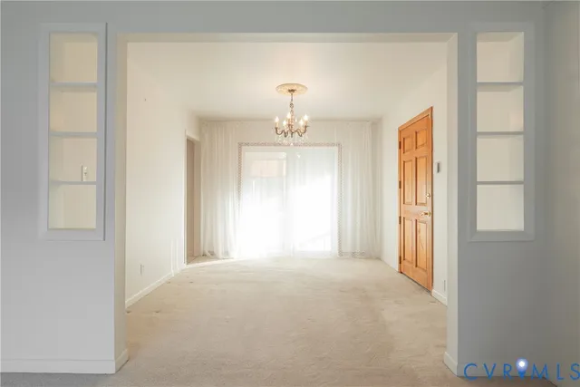 a view of a chandelier in big room and windows