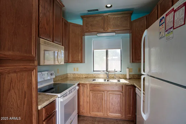 a view of a dining room with furniture and a window