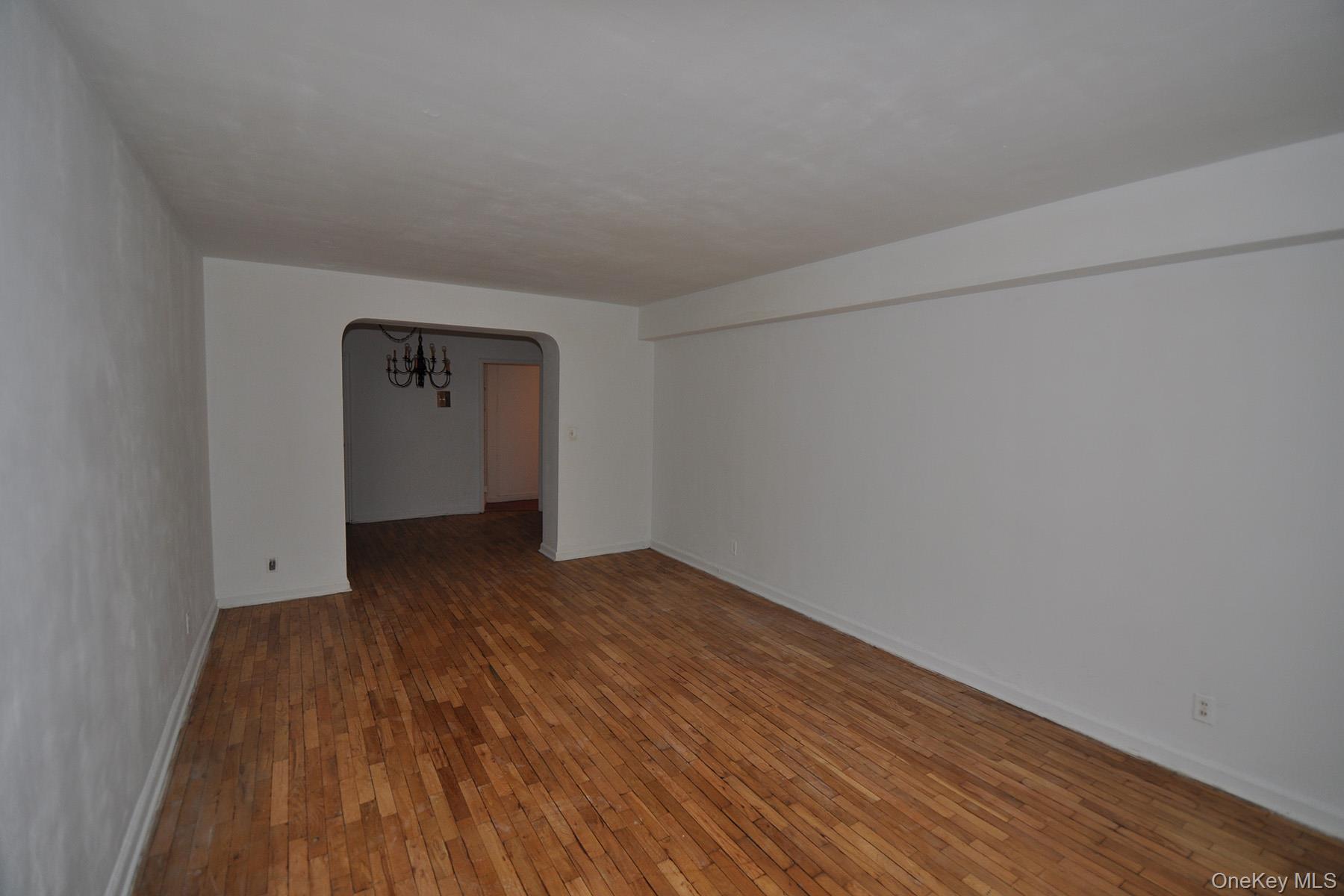 a view of an empty room and wooden floor