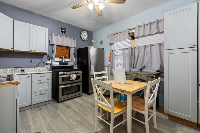 a kitchen with stainless steel appliances a stove refrigerator sink and microwave