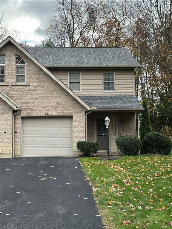 131 Windy Drive Butler, PA 16001 - Photo 1 of 24 a front view of a house with garden