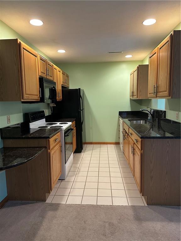 131 Windy Drive Butler, PA 16001 - Photo 12 of 24 a kitchen with stainless steel appliances granite countertop a stove a sink and a microwave