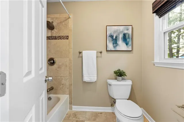 a bathroom with a toilet a sink and a shower