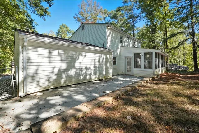 a backyard of a house with table and chairs