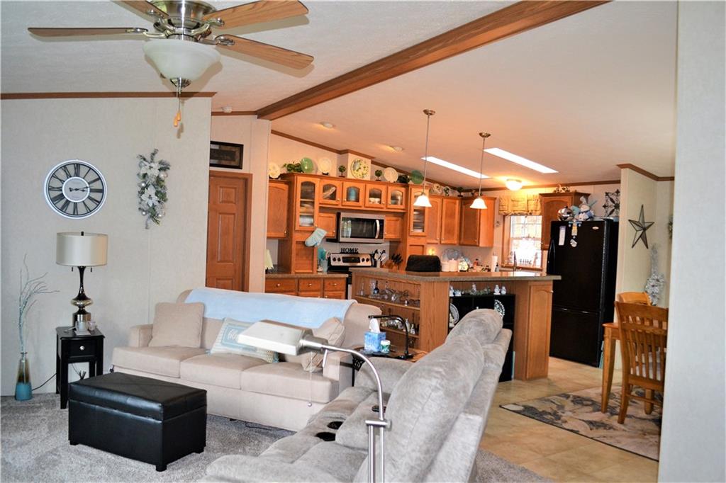 222 Toy Road Kittanning, PA 16201 - Photo 8 of 25 a living room with furniture a chandelier and a fireplace