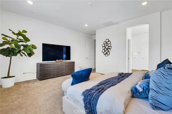 a bedroom with a bed and a flat screen television