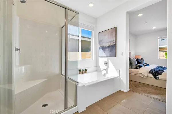 a bathroom with a bathtub shower and a sink
