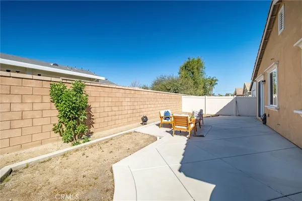 a backyard of a house with outdoor seating