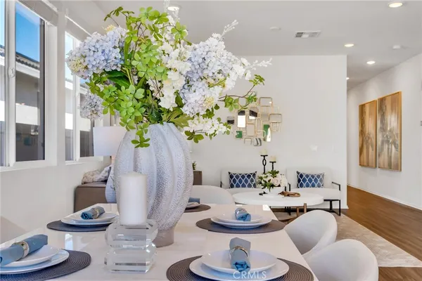 a dining room with furniture and a potted plant