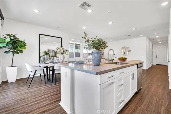 a kitchen with sink and view of living room