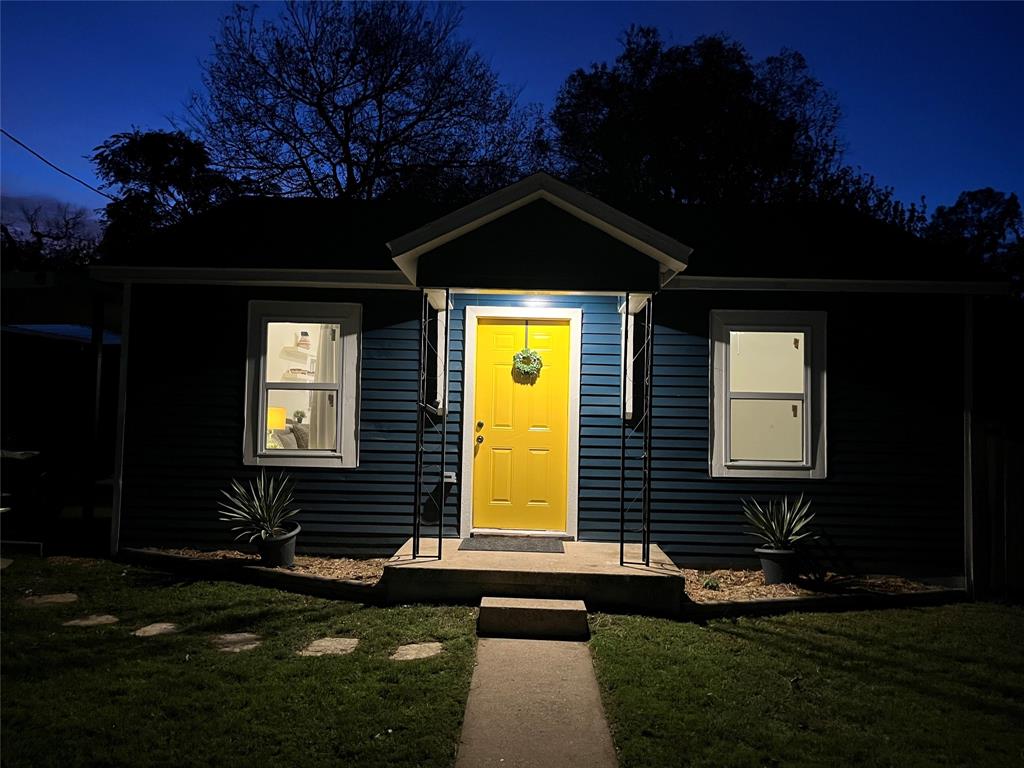315 Hobson Street Weatherford, TX 76086 - Photo 24 of 24 Charming blue siding exterior featuring a bright yellow front door with a decorative wreath