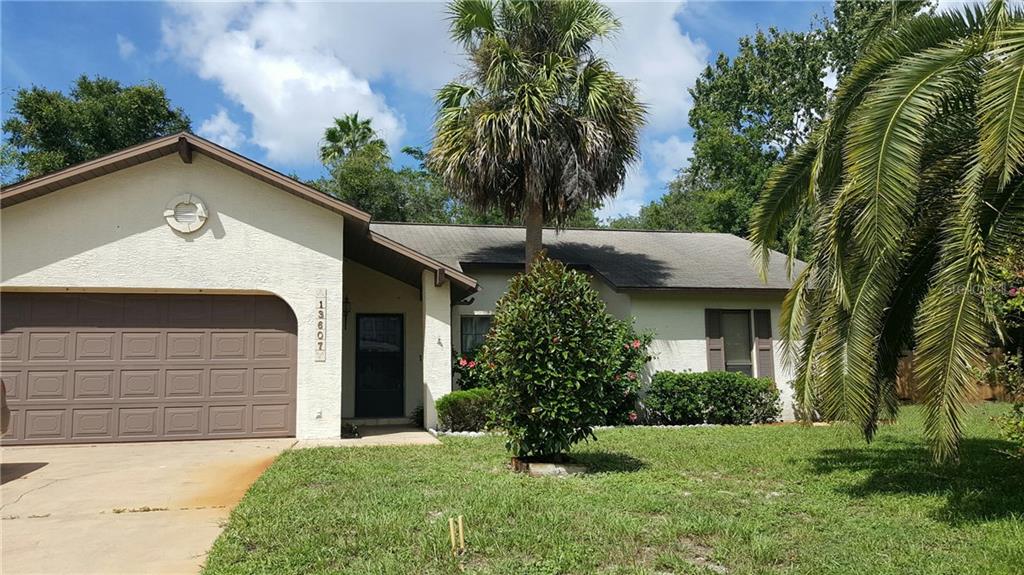 13607 Whitby Road Hudson, FL 34667 - Photo 1 of 1 a front view of a house with a yard