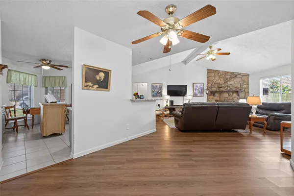 a living room with furniture kitchen view and a fireplace