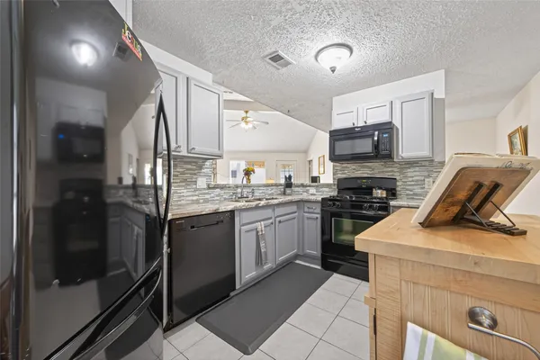 a kitchen with a sink stainless steel appliances and cabinets