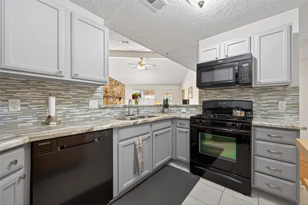 a kitchen with appliances cabinets and a sink