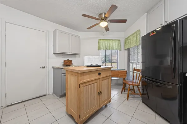 a kitchen with appliances cabinets and a refrigerator